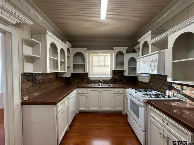 a kitchen with stainless steel appliances granite countertop a sink and a stove