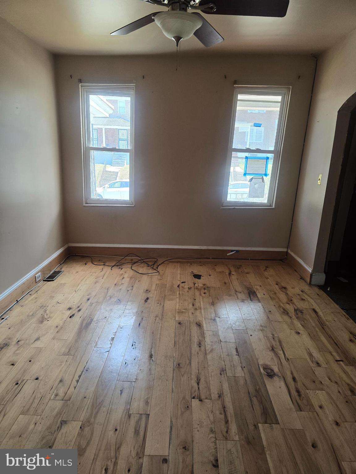 930 North Rosedale Street Baltimore, MD 21216 - Photo 3 of 9 wooden floor in an empty room with a window