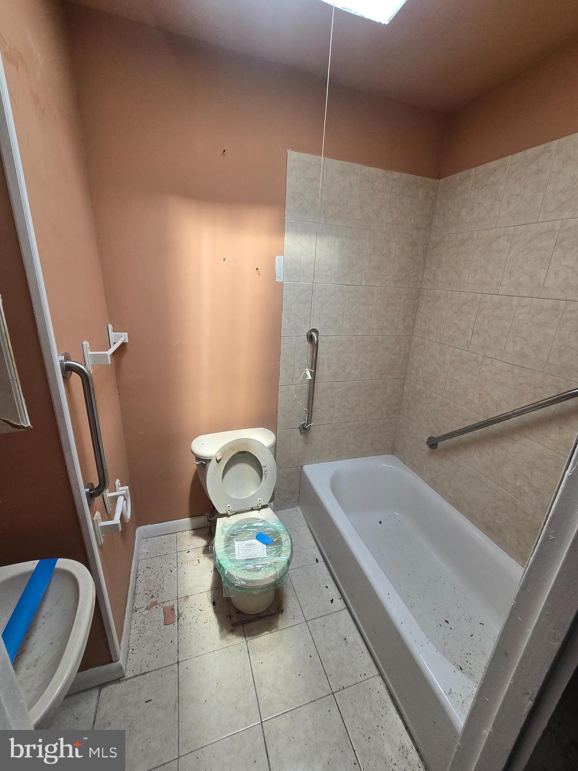 930 North Rosedale Street Baltimore, MD 21216 - Photo 6 of 9 a bathroom with a sink and a tub