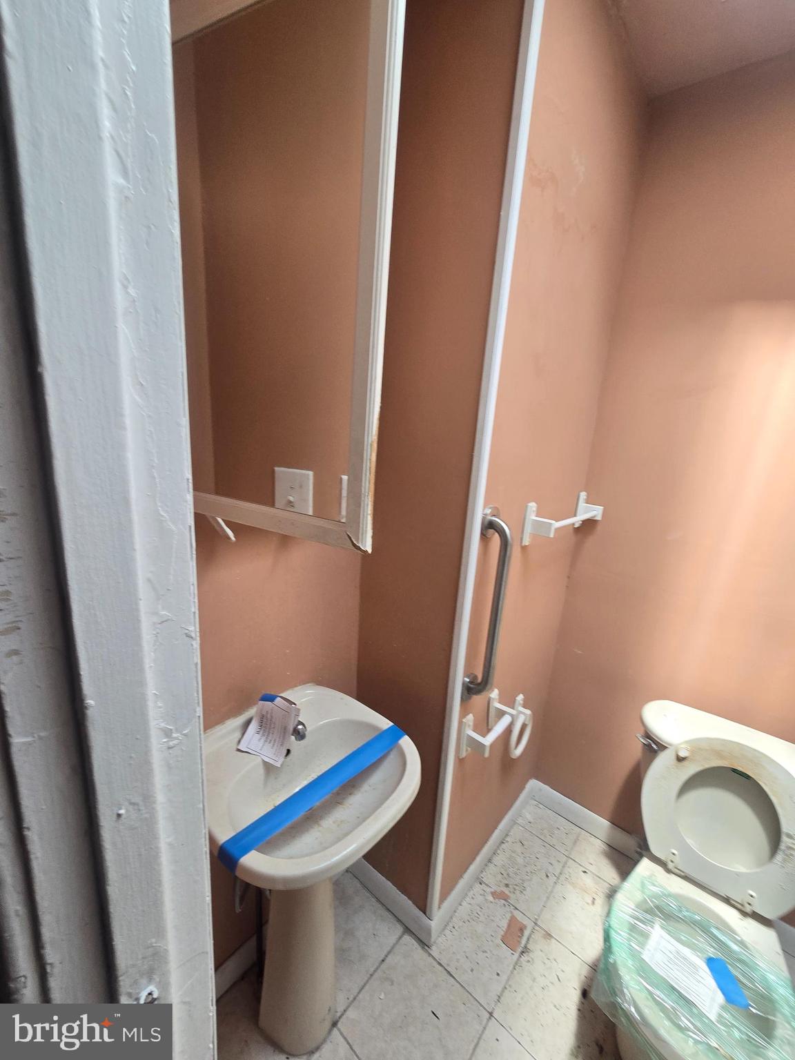 930 North Rosedale Street Baltimore, MD 21216 - Photo 7 of 9 a bathroom with a sink and a toilet