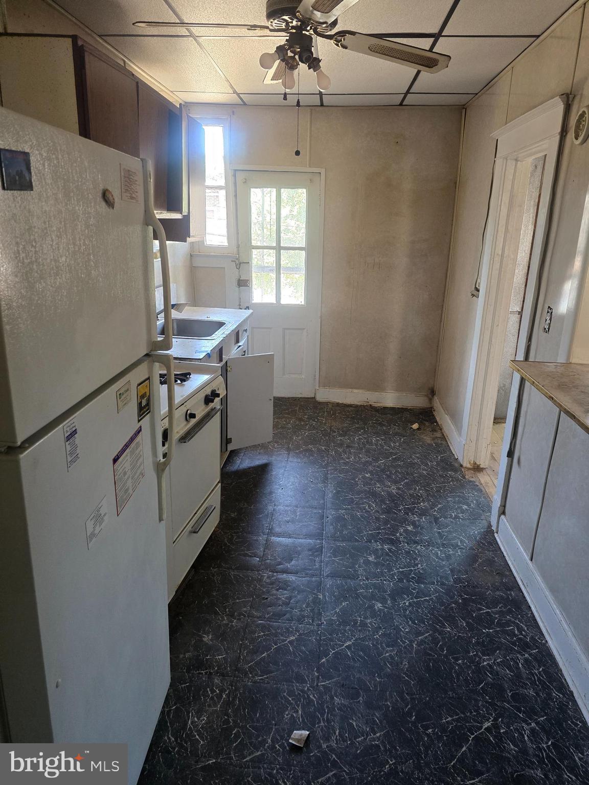 930 North Rosedale Street Baltimore, MD 21216 - Photo 8 of 9 a kitchen with granite countertop a sink a refrigerator a washer and dryer