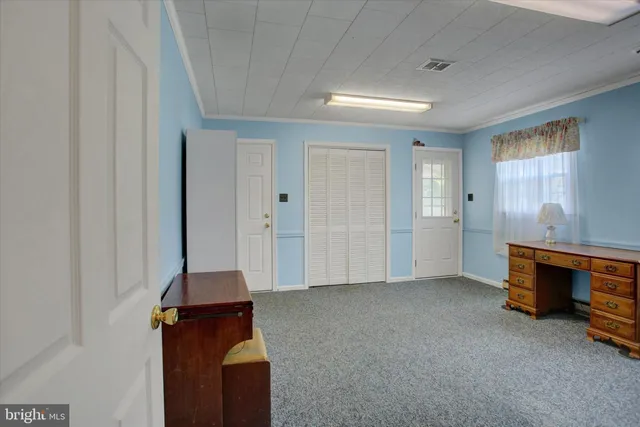 a view of a small space with wooden floor and a window