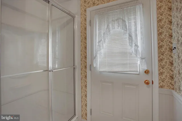 a kitchen with a chair and cabinets