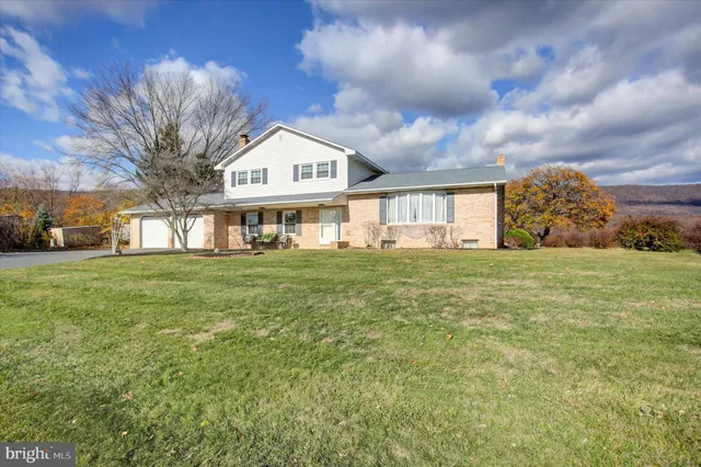 a view of a house with a yard and garage