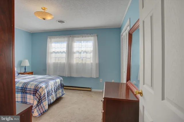 a view of a livingroom with a chair and a fireplace