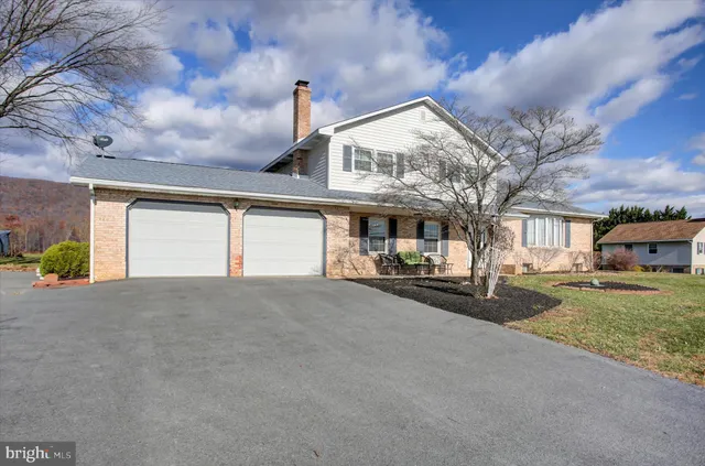 a view of a house with a yard and garage