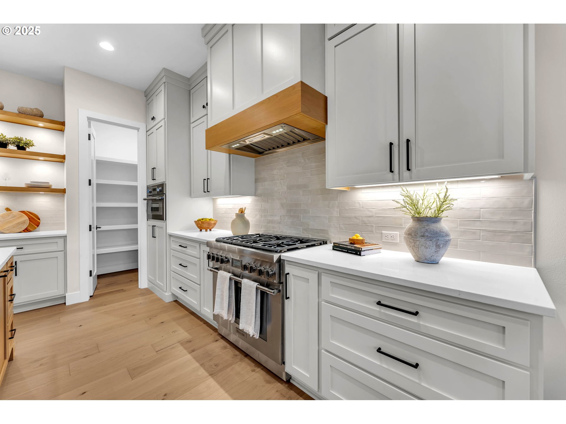 17716 Northeast 25th Avenue Ridgefield, WA 98642 - Photo 21 of 48 a kitchen with a stove and white cabinets