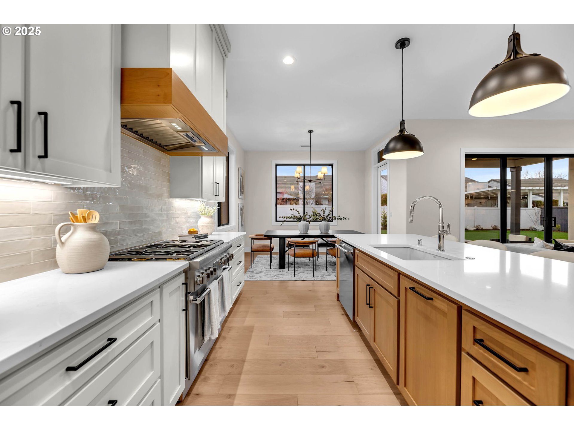 17716 Northeast 25th Avenue Ridgefield, WA 98642 - Photo 25 of 48 a kitchen with stainless steel appliances granite countertop a sink a stove and a wooden floors