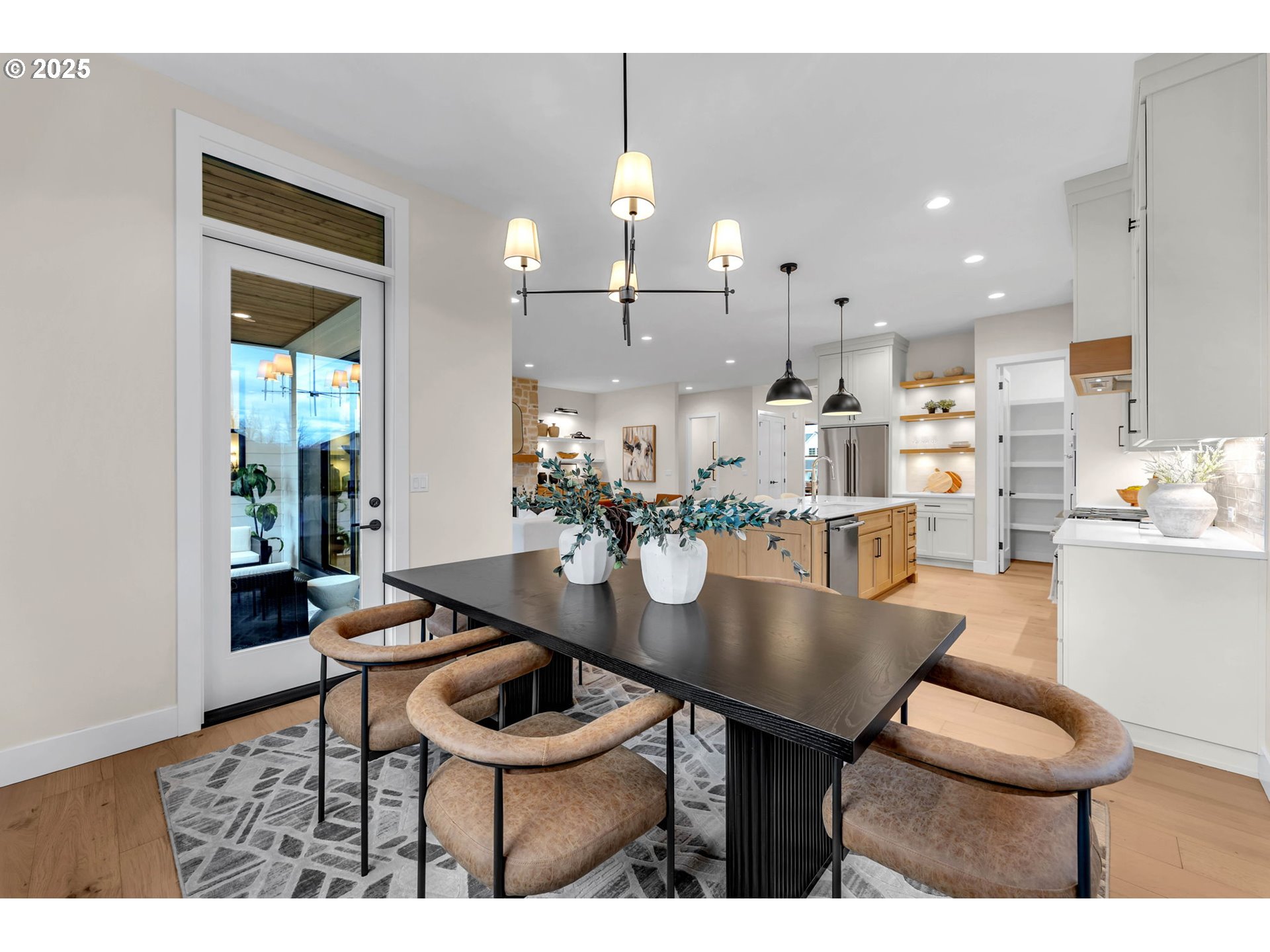 17716 Northeast 25th Avenue Ridgefield, WA 98642 - Photo 26 of 48 a dining room with furniture and a chandelier