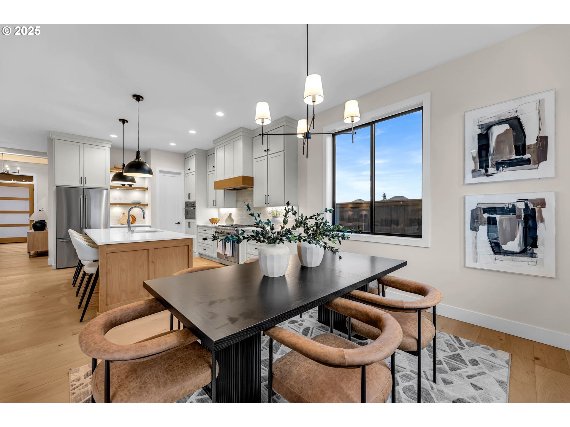 17716 Northeast 25th Avenue Ridgefield, WA 98642 - Photo 27 of 48 a kitchen with a table chairs stove and kitchen island