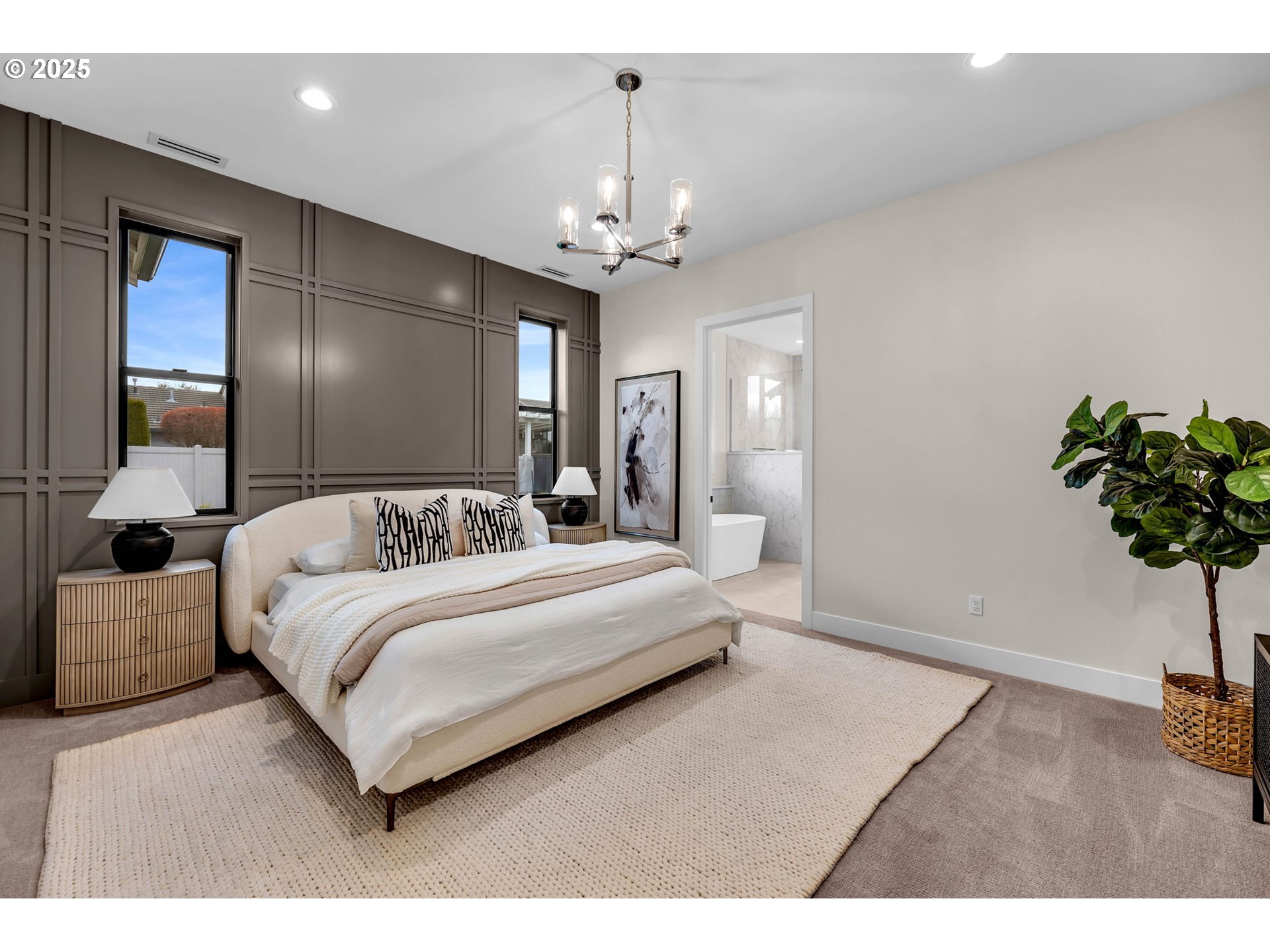 17716 Northeast 25th Avenue Ridgefield, WA 98642 - Photo 28 of 48 a spacious bedroom with a bed and a chandelier