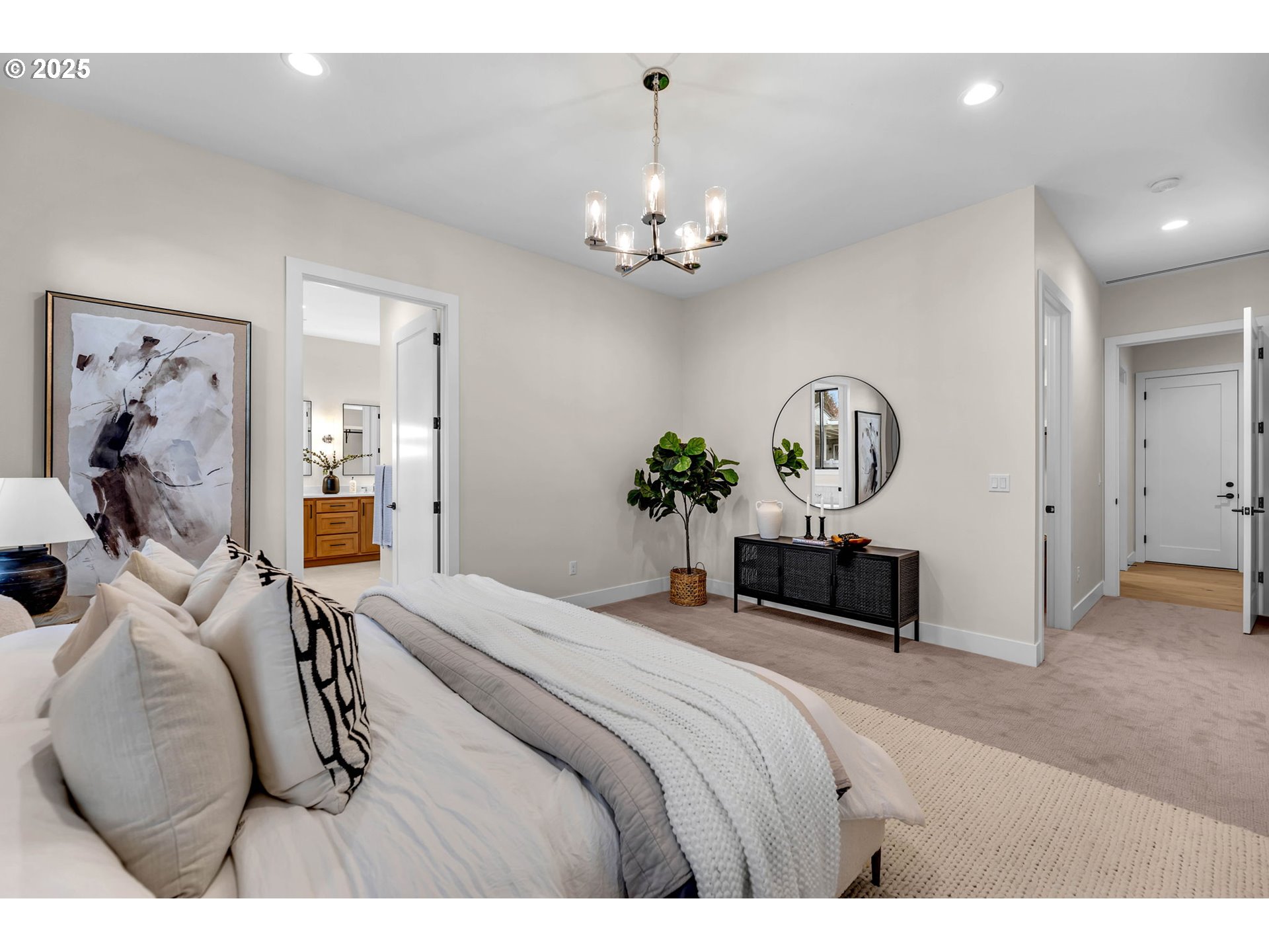 17716 Northeast 25th Avenue Ridgefield, WA 98642 - Photo 29 of 48 a bedroom with a bed ceiling fan and a chandelier
