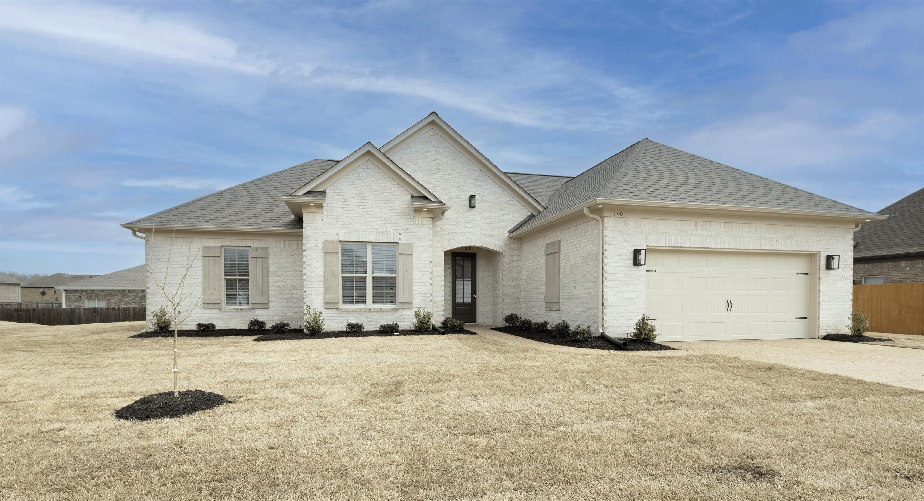 140 Oakland Rdg Cove Oakland, TN 38060 - Photo 3 of 30 View of front of house with brick siding, a garage, roof with shingles, and driveway