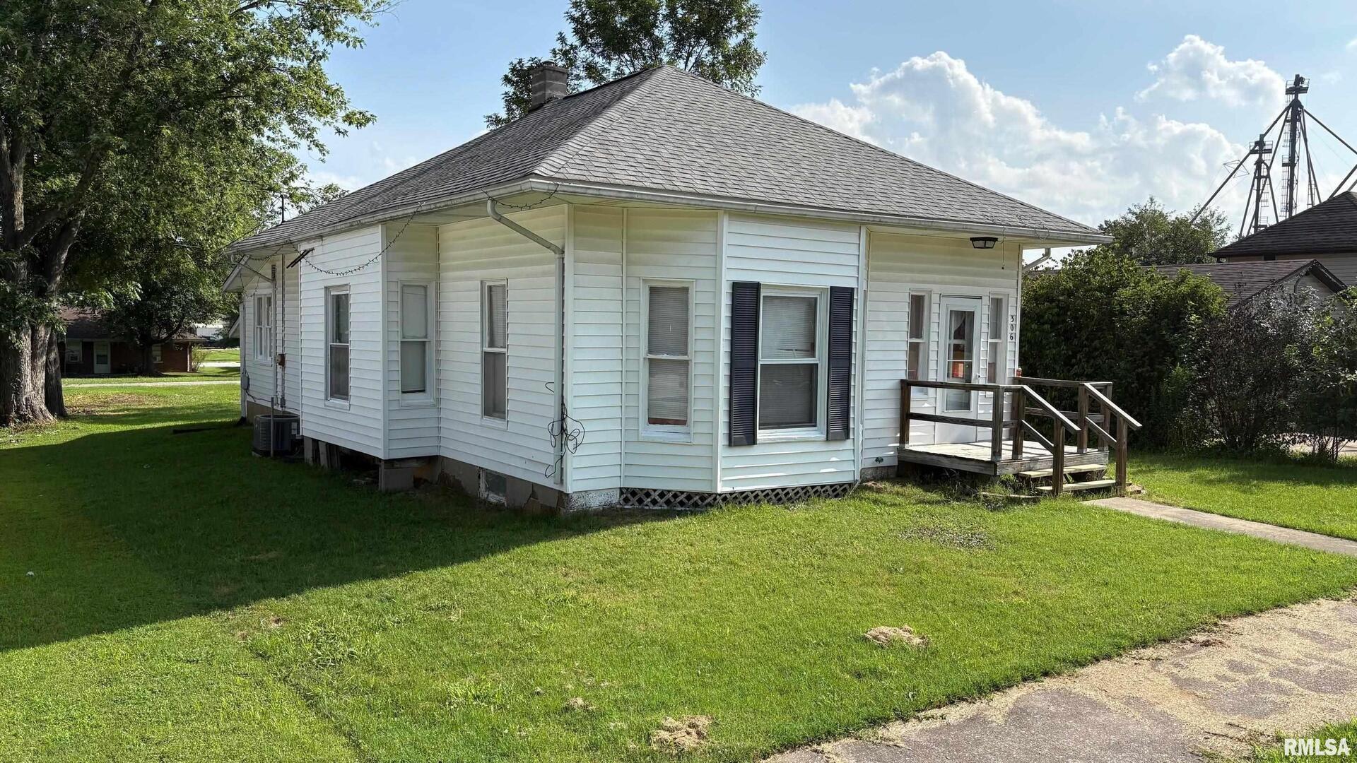 a view of a house with backyard porch and sitting area