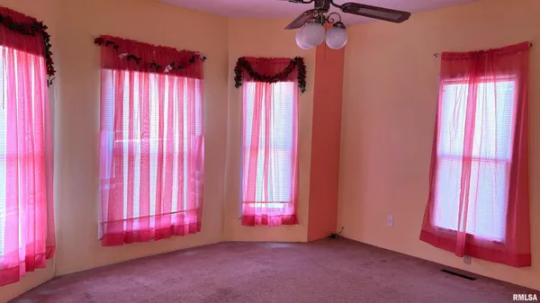a view of a room with a fireplace and a window