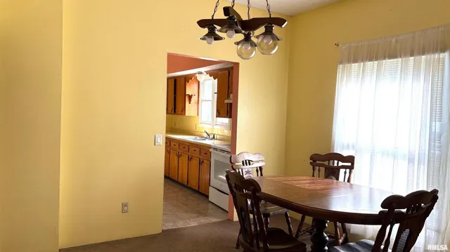 a view of a dining room with a table and chairs