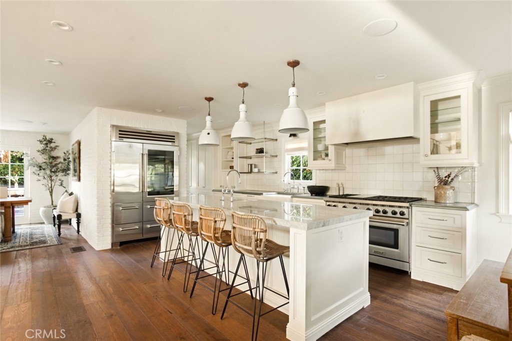 326 Ruby Street Laguna Beach, CA 92651 - Photo 12 of 71 a kitchen with stainless steel appliances white cabinets and wooden floor
