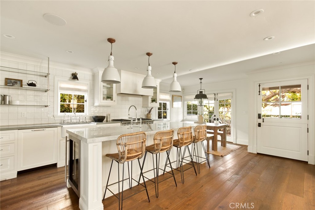 326 Ruby Street Laguna Beach, CA 92651 - Photo 15 of 71 a kitchen with stainless steel appliances kitchen island wooden floors and white cabinets