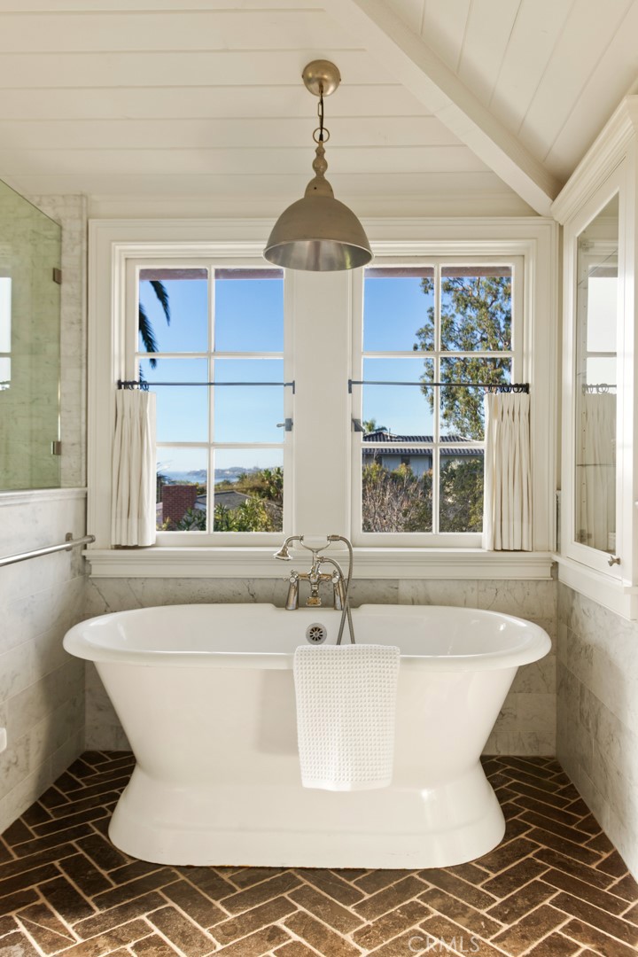 326 Ruby Street Laguna Beach, CA 92651 - Photo 32 of 71 a white bath tub sitting in a bathroom next to a window
