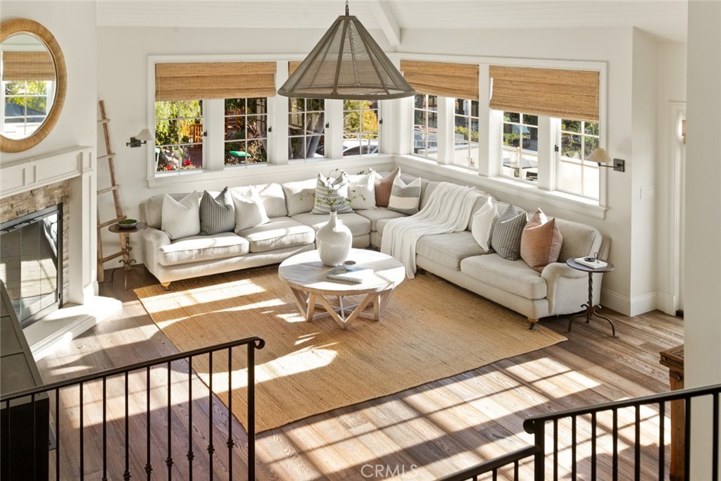 326 Ruby Street Laguna Beach, CA 92651 - Photo 5 of 71 a living room with furniture a fireplace and a floor to ceiling window