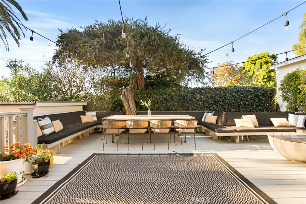 326 Ruby Street Laguna Beach, CA 92651 - Photo 59 of 71 a view of a patio with couches and a table and chairs with wooden floor