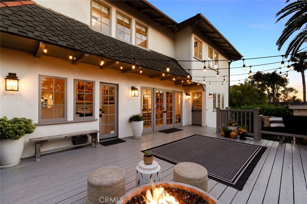 326 Ruby Street Laguna Beach, CA 92651 - Photo 68 of 71 a view of a patio with table and chairs with wooden floor and fence