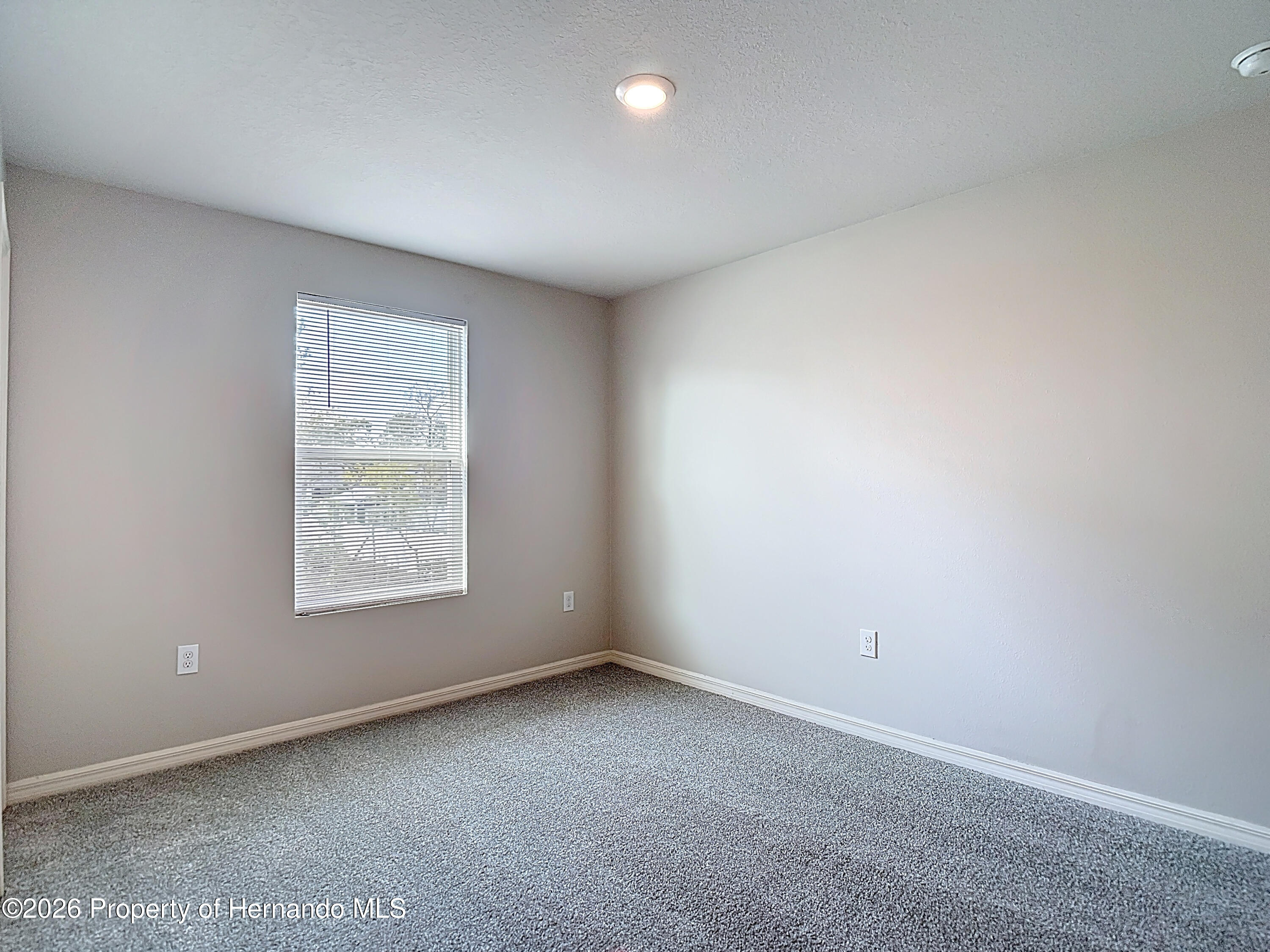 11374 Marcella Avenue Weeki Wachee, FL 34614 - Photo 48 of 70 an empty room with a window