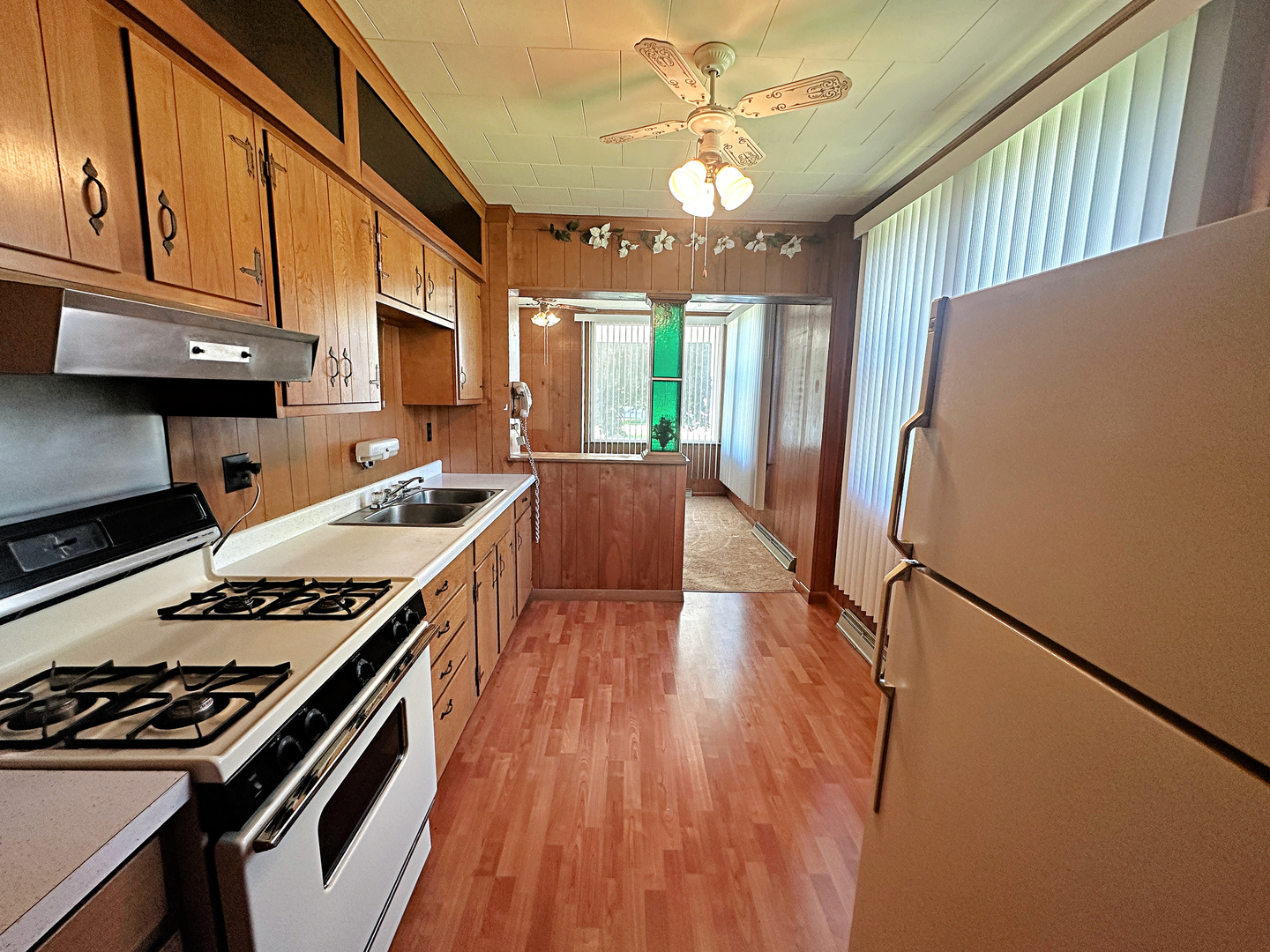 505 Morgan Street Long Point, IL 61333 - Photo 13 of 36 a kitchen with granite countertop a stove a sink dishwasher and a refrigerator with wooden floor