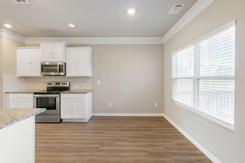 760 McCart Road Lawrenceville, GA 30045 - Photo 12 of 40 a kitchen with granite countertop white cabinets and appliances