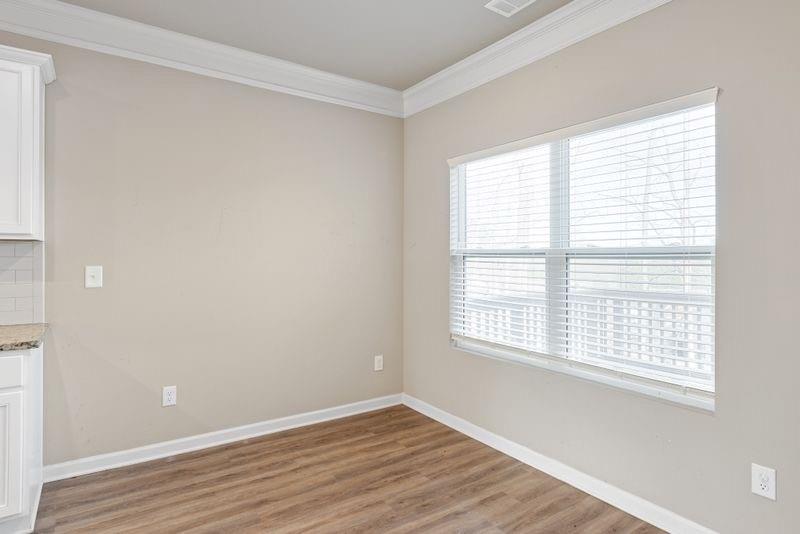 760 McCart Road Lawrenceville, GA 30045 - Photo 13 of 40 a view of an empty room with wooden floor and a window