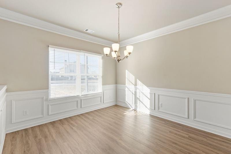 760 McCart Road Lawrenceville, GA 30045 - Photo 18 of 40 a view of an empty room with wooden floor and a window