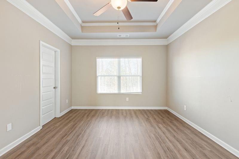 760 McCart Road Lawrenceville, GA 30045 - Photo 20 of 40 an empty room with a hardwood and ceiling fan