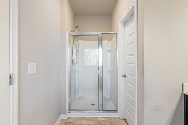 760 McCart Road Lawrenceville, GA 30045 - Photo 25 of 40 a bathroom with a glass shower door