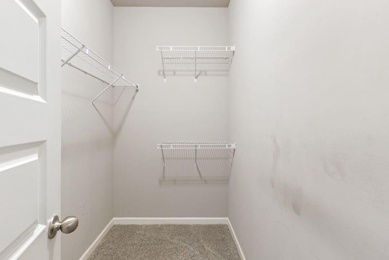 760 McCart Road Lawrenceville, GA 30045 - Photo 26 of 40 a view of walk in closet with empty racks