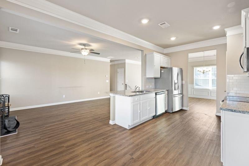 760 McCart Road Lawrenceville, GA 30045 - Photo 9 of 40 a large kitchen with a wooden floor and a large window