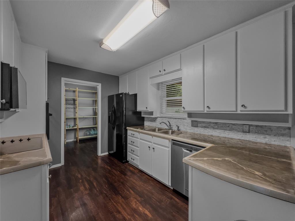220 Cooper Drive Hurst, TX 76053 - Photo 8 of 27 a kitchen with a sink a stove and refrigerator
