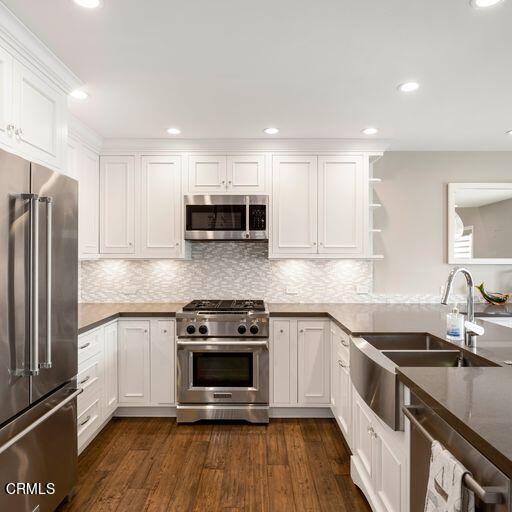 3241 Harbor Boulevard Oxnard, CA 93035 - Photo 8 of 32 a kitchen with stainless steel appliances a stove a sink and a microwave