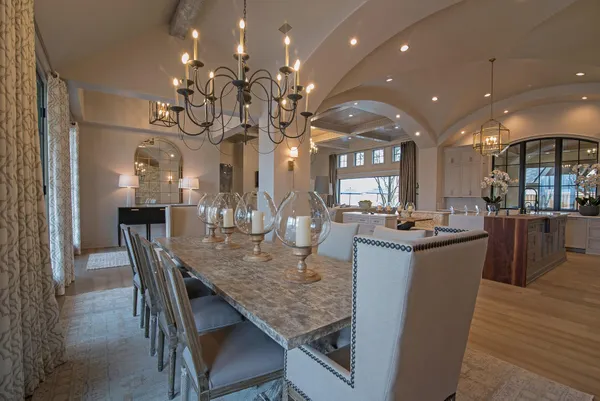 a living room with furniture a chandelier and a fireplace