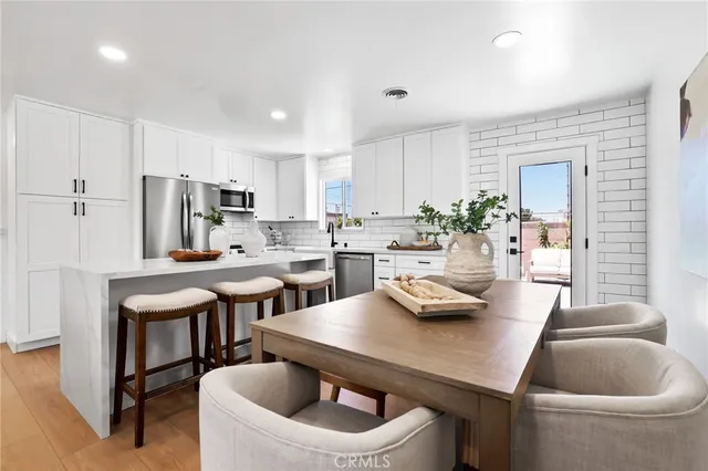 a kitchen with a table and chairs