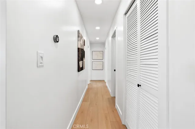 a view of a hallway with wooden floor