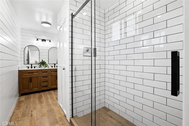 a bathroom with a double vanity sink mirror and shower