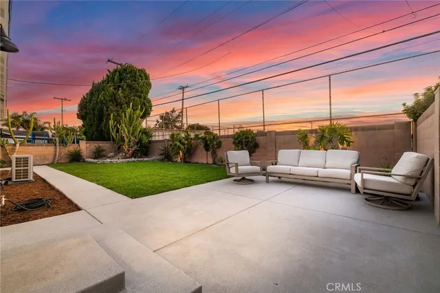 a view of backyard with seating area and green space