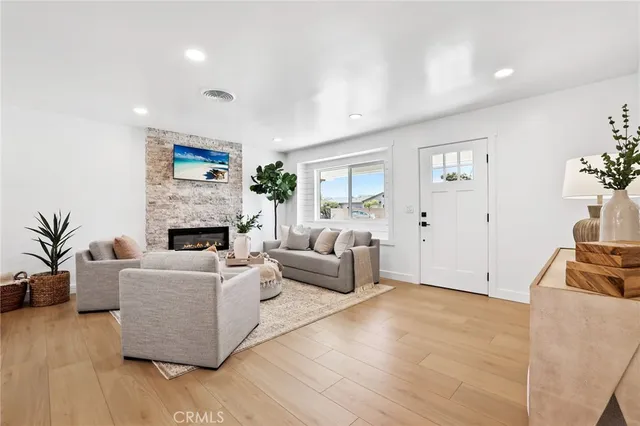 a living room with furniture a fireplace and a flat screen tv