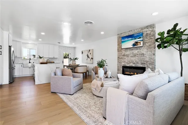 a living room with furniture a fireplace and a potted plant