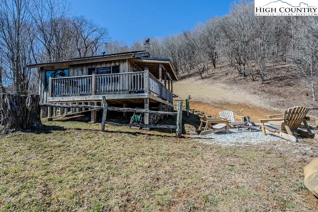 a view of a house with a yard and sitting area
