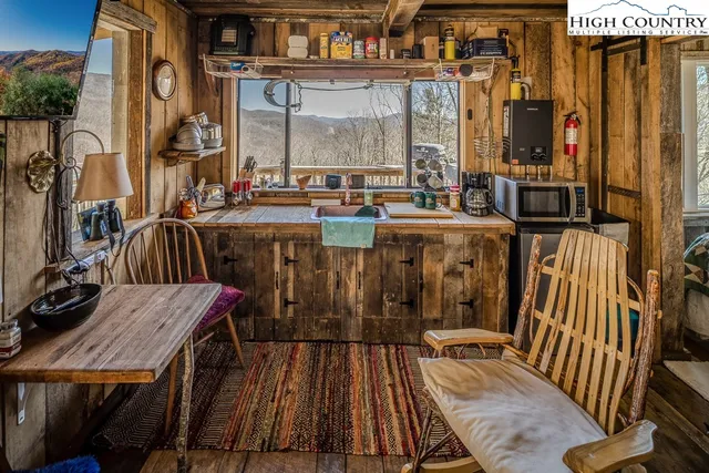 a living room with furniture a rug and a window