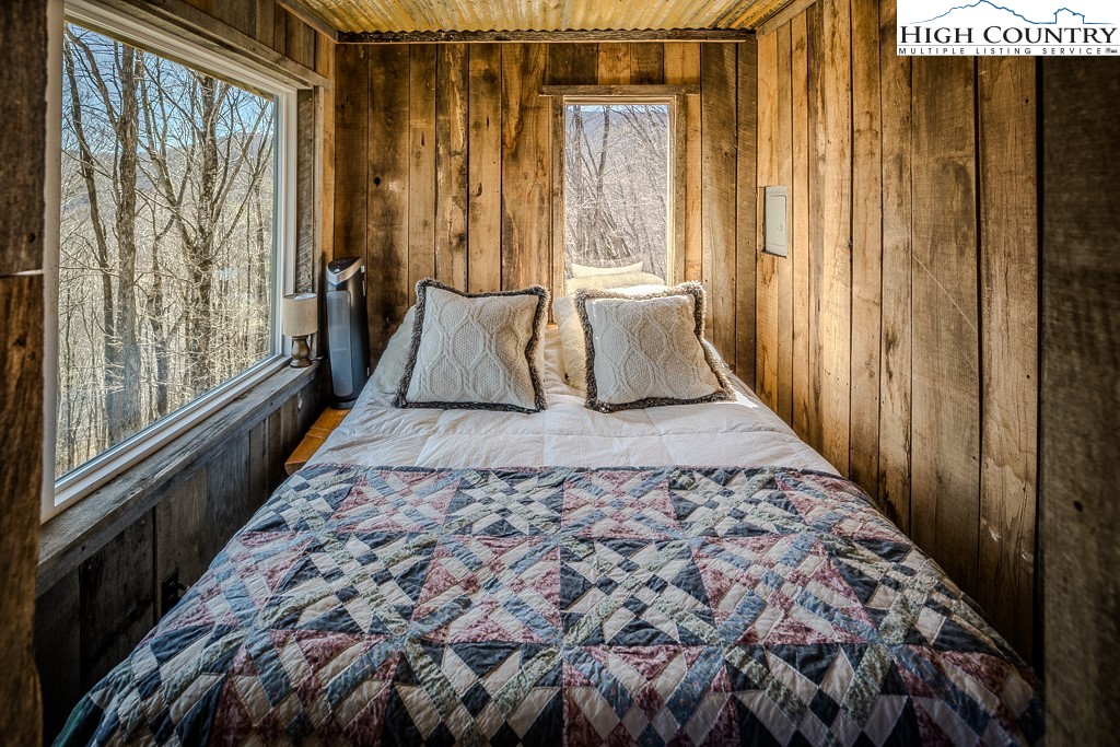 Jerry's Creek Road Newland, NC 28657 - Photo 33 of 49 a large bed sitting in a bedroom next to a window