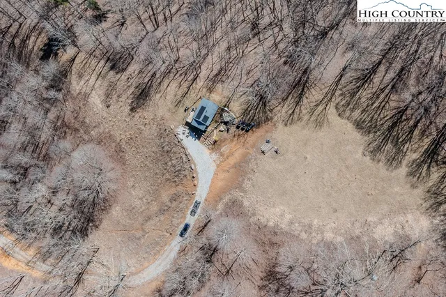a view of a dry yard with mountains in the background