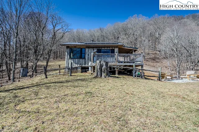 a view of a house with wooden fence