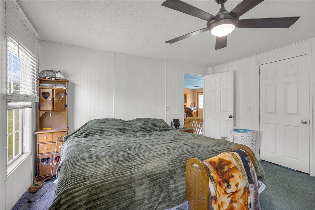 1549 Bethany Church Road Belton, SC 29627 - Photo 23 of 36 A comfortable bedroom featuring a ceiling fan and natural light from a window.
